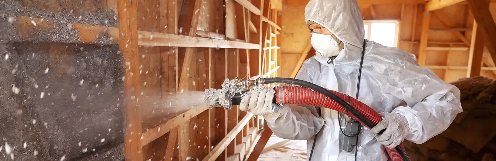 A technician performing an insulation service