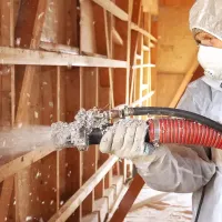 a blower installing insulation